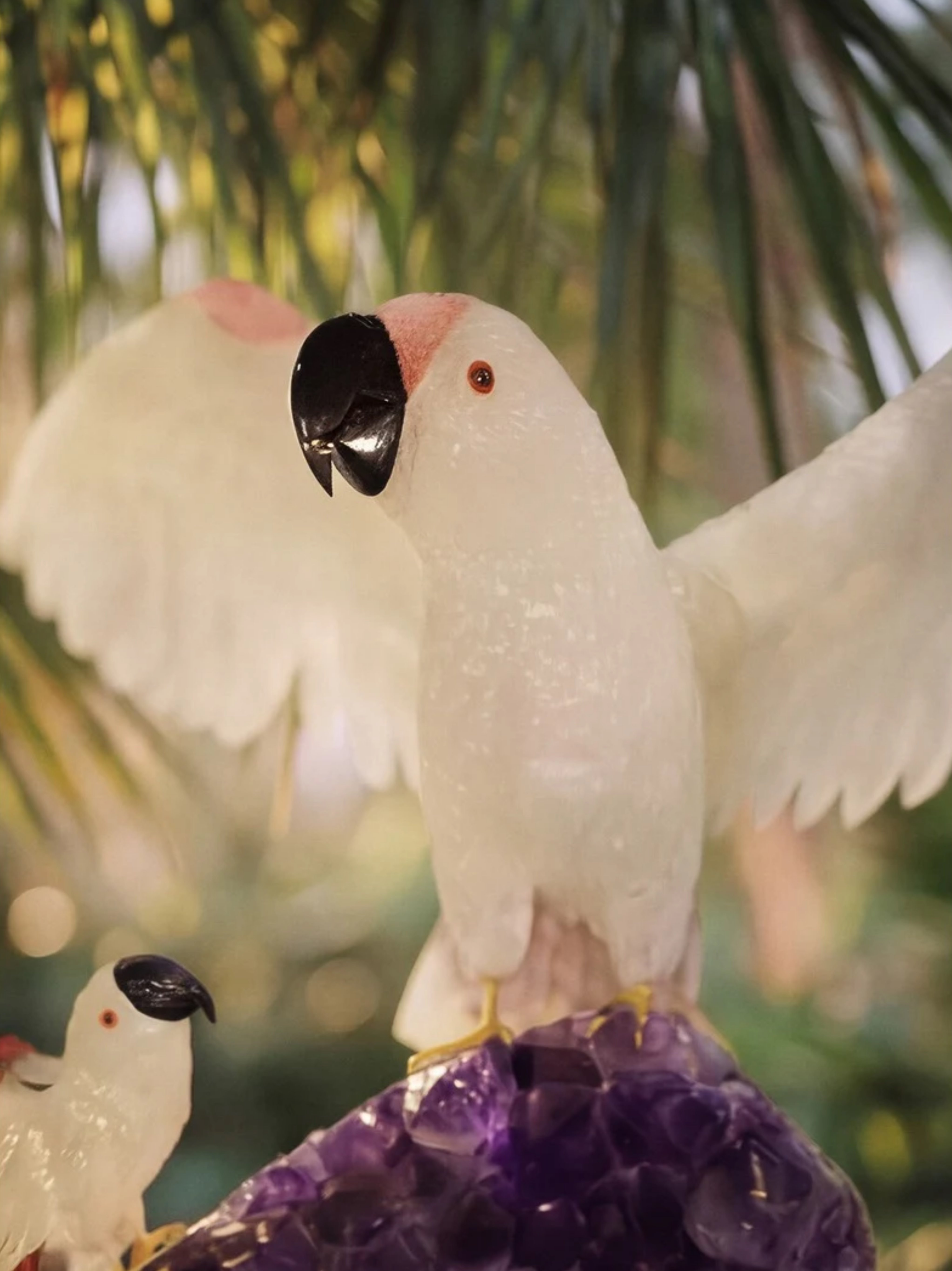 Blue macaws crystal sculpture at sunset