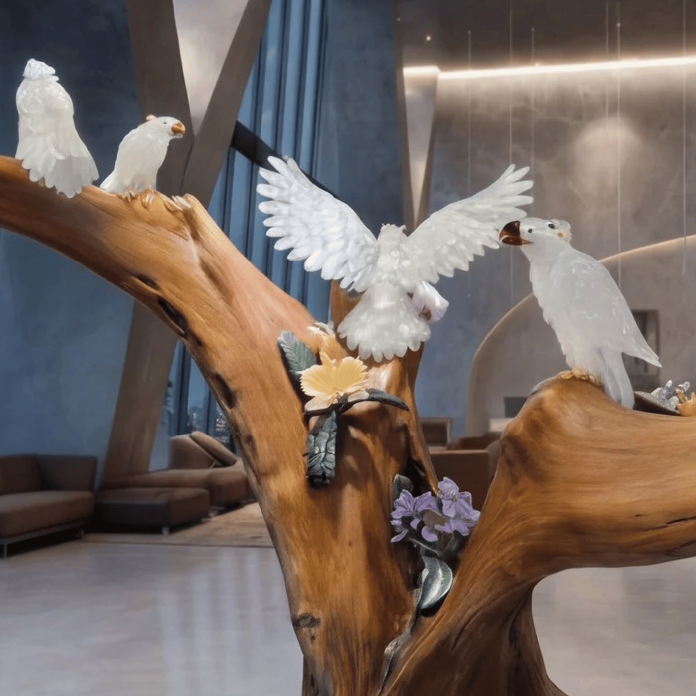 White crystal cockatoos in luxury modern lobby — PHAÖRA sculpture