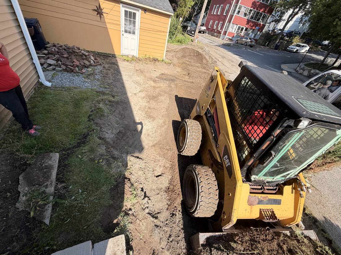 The driveway excavated down to grade, with the drainage pitch being set