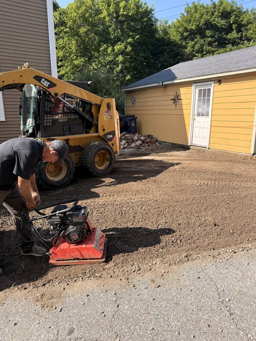Processed stone base going in and being compacted in lifts
