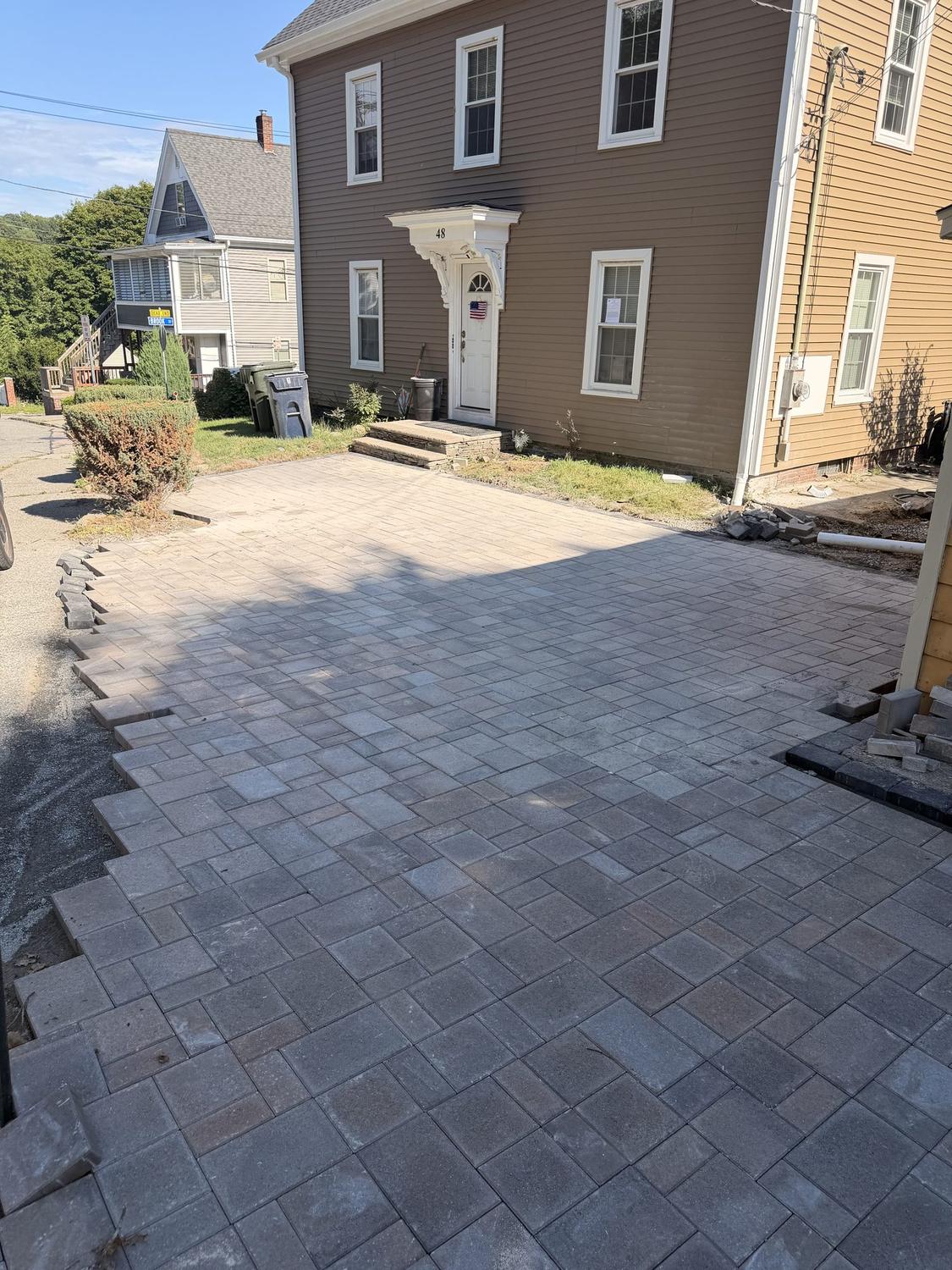 After — the paver driveway carried right up to the front door steps