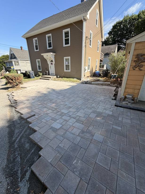 Paver field meeting the garage apron