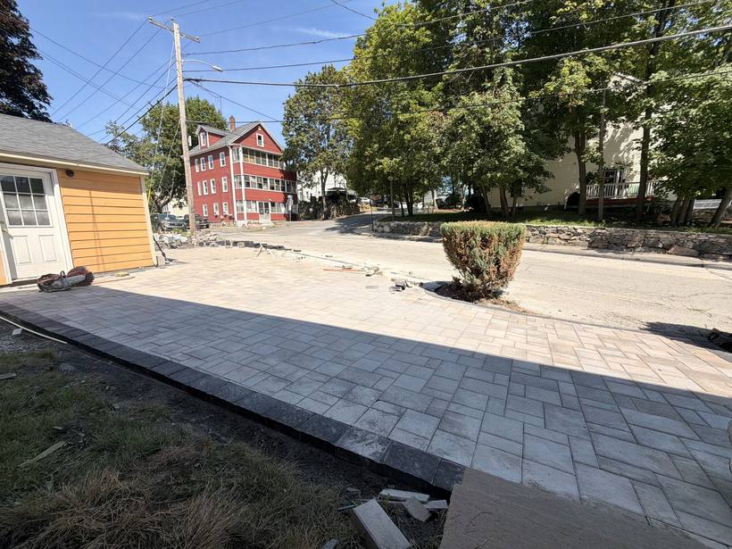 Large-format pavers laid to pattern across the driveway