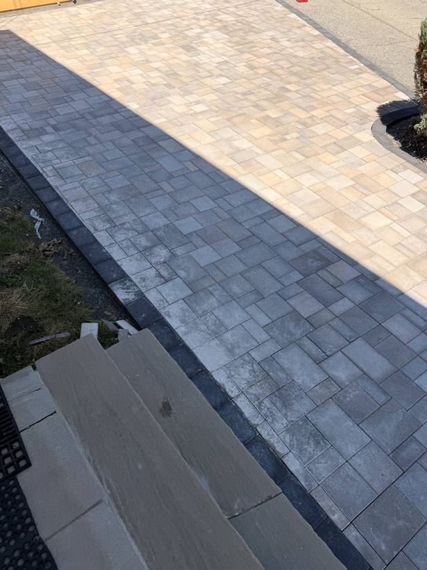 The restrained edge where the pavers meet the lawn