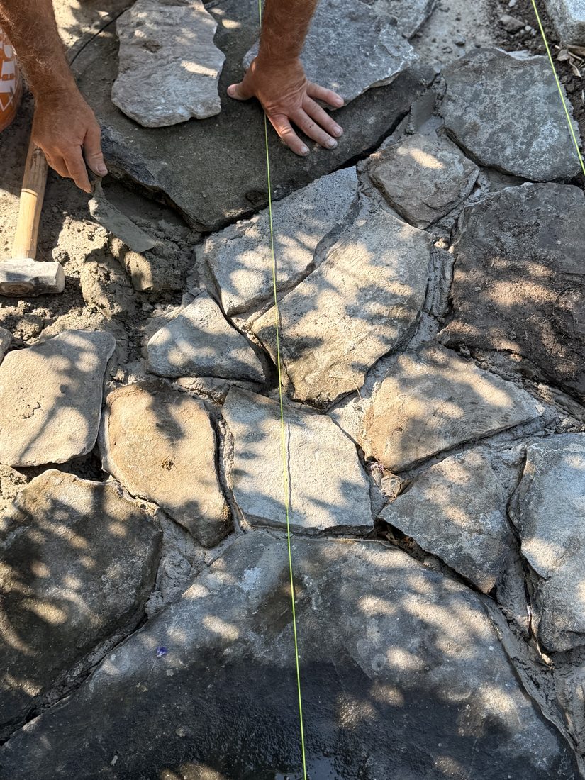 Irregular flagstone seen from above, hand-cut so the joints stay tight