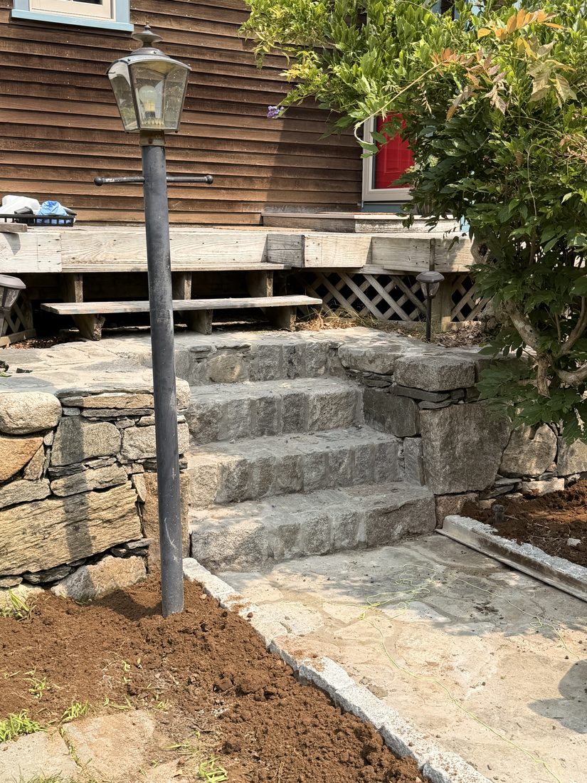 Solid granite block steps rising from the walk to the deck