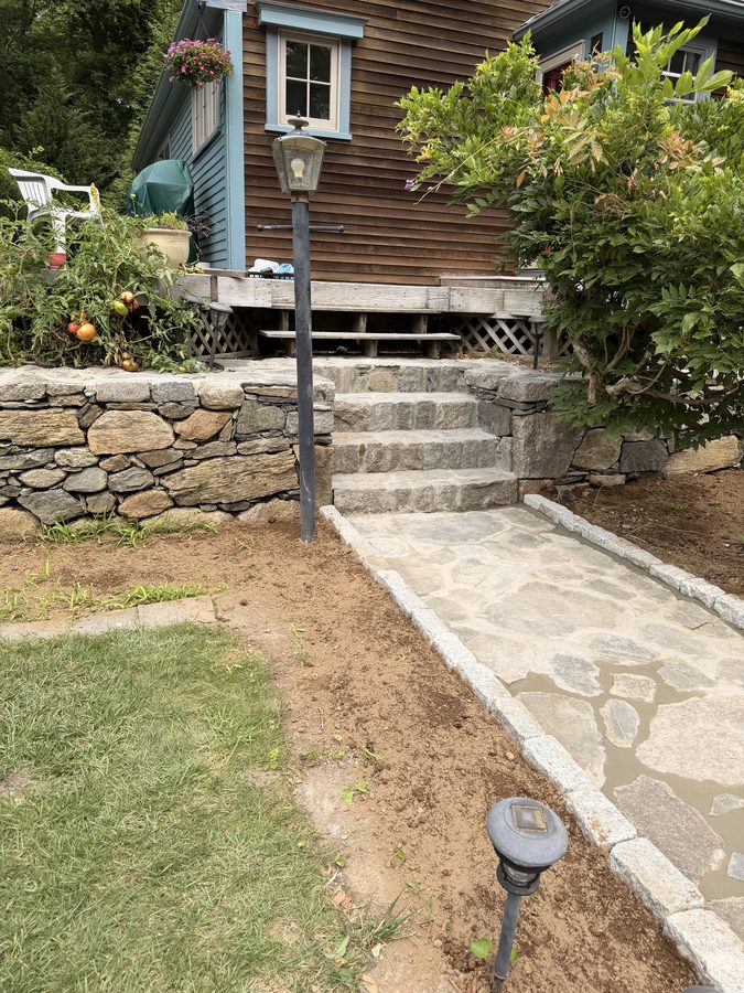 The walk and granite steps with the lamp post and fieldstone wall alongside