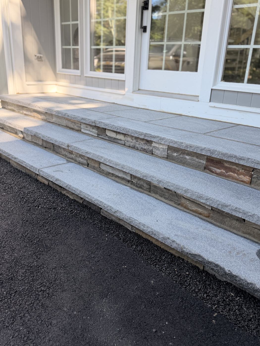 The steps and landing seen from the drive, doors above