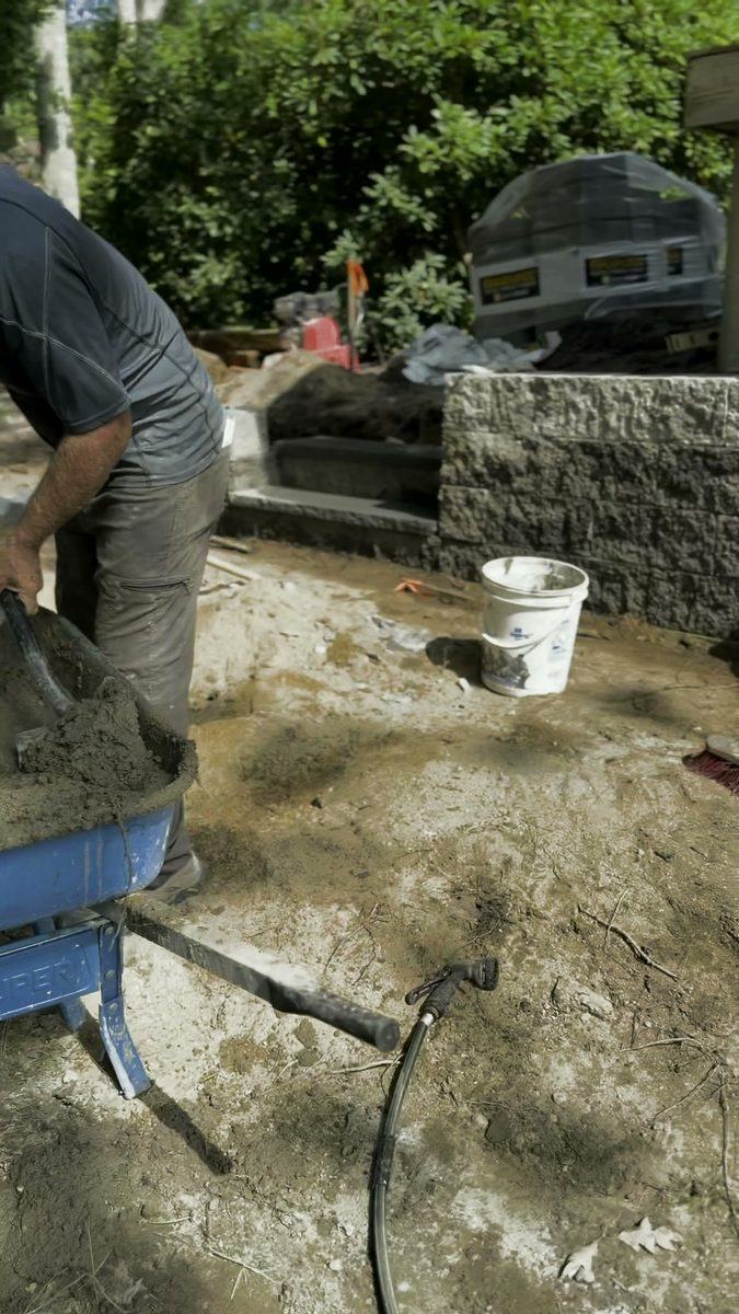 Mixing mortar alongside the finished course
