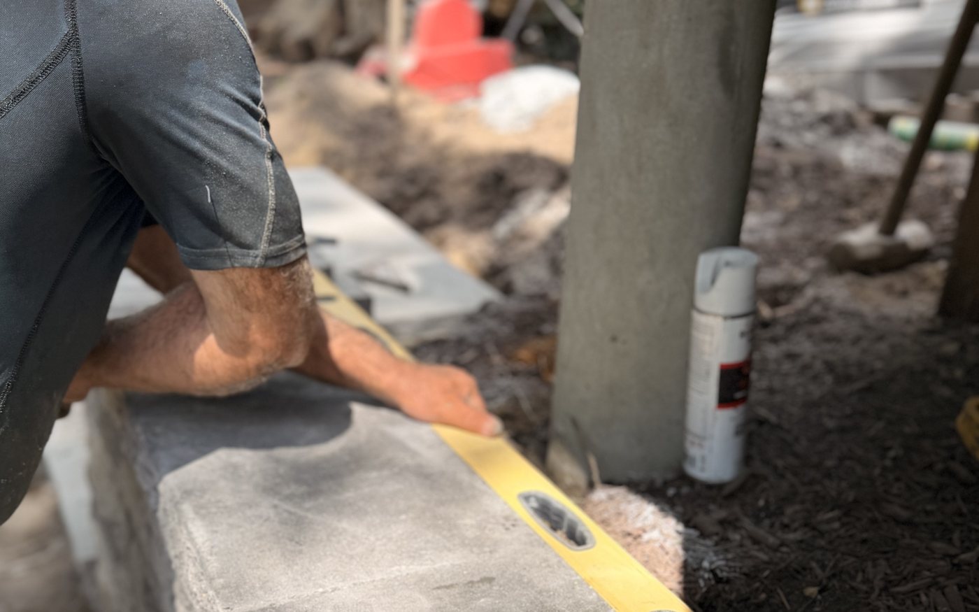Levelling a cap stone on a block retaining wall under construction