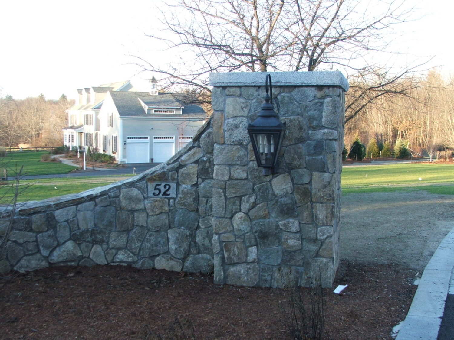 Fieldstone entrance wall with lantern