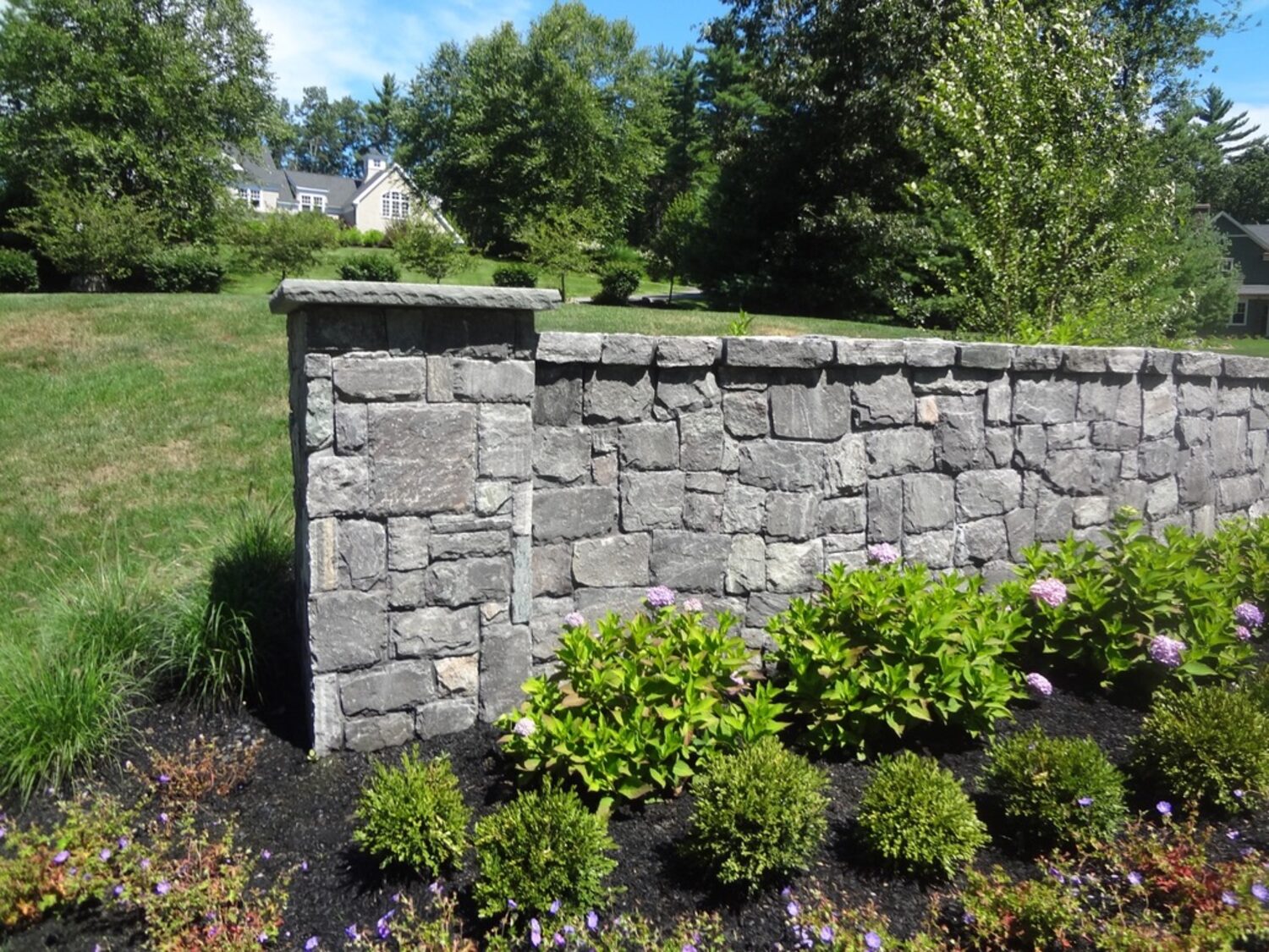 Landscaped fieldstone garden wall