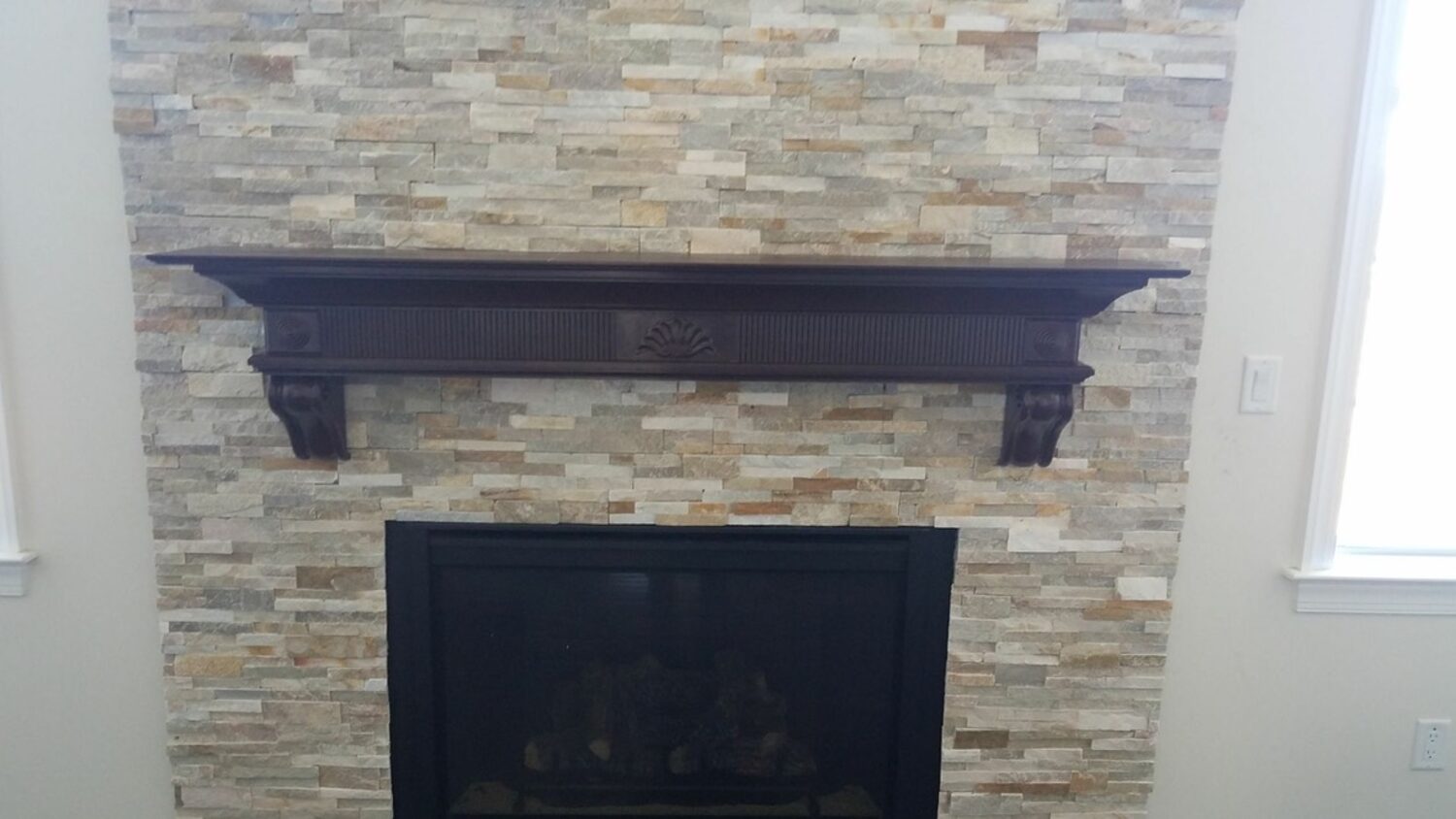 Interior stone veneer fireplace
